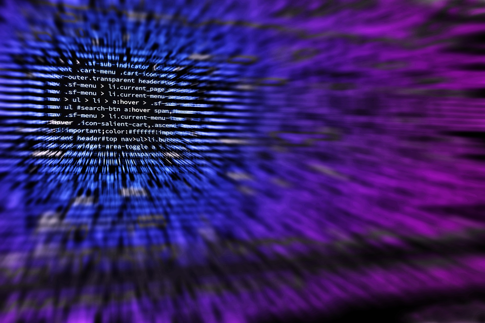 HTML code on a computer screen surrounded by purple light