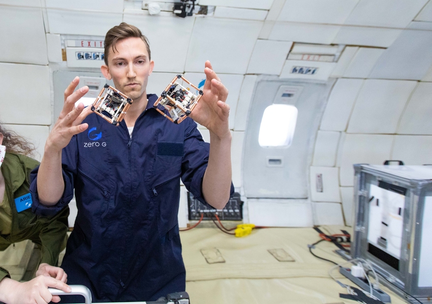 Caption:MIT PhD student Martin Nisser tests self-reconfiguring robot blocks, or ElectroVoxels, in microgravity.