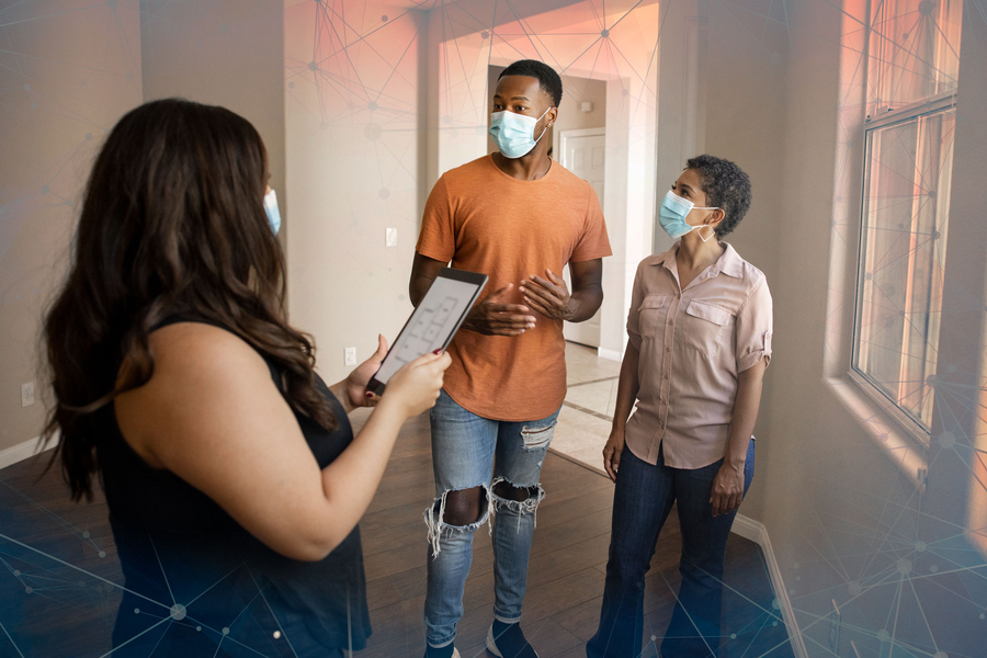 Couple touring a home and applying for a mortgage