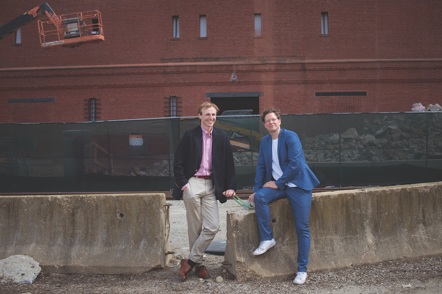 two men outside building posing retrofit