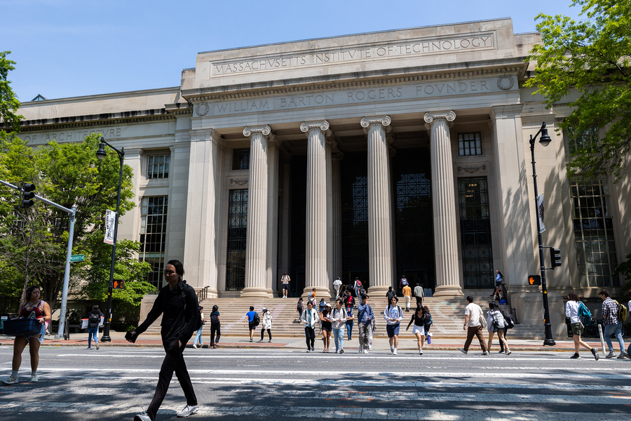 People cross Mass Ave, with the columns and steps off Lobby 7 in background.