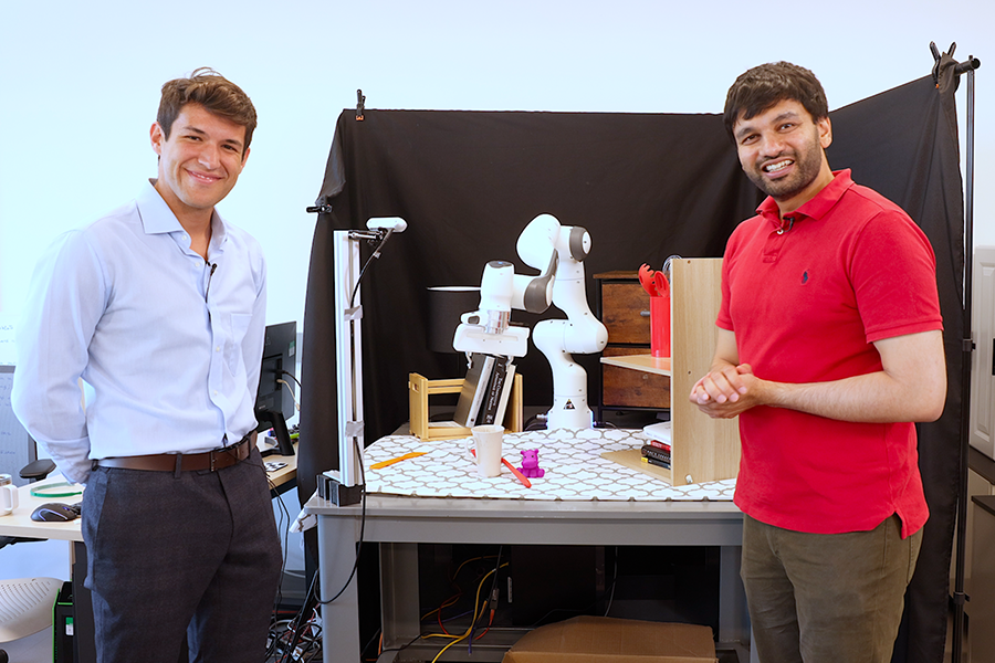 With the help of “digital twins,” RialTo, developed by MIT researchers Marcel Torne Villasevil (left) and Pulkit Agrawal, can guide a robot to practice in a simulated environment much faster than it would if it honed its skills in the real world (Credits: Mike Grimmett/MIT CSAIL).