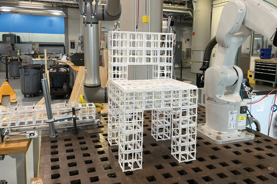 Given the prompt “Make me a chair” and feedback “I want panels on the seat,” the robot assembles a chair and places panel components according to the user prompt (Credits: Courtesy of the researchers).