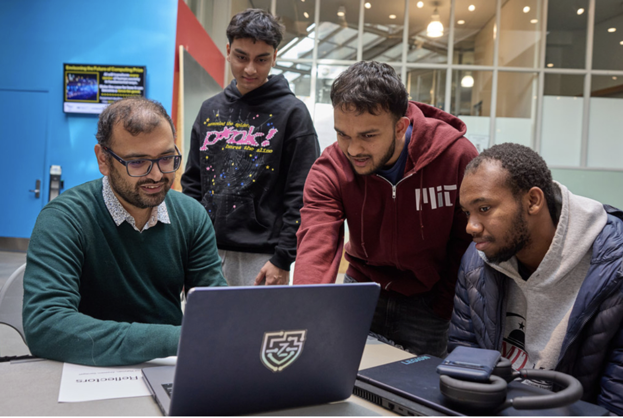 Senior Mohammed Ihtisham (second from right) explains Project Reflecto to MIT professor of computer science Arvind Satyanarayan (left), as junior Nayeemur Rahman (second from left) and senior Alqasem Senegali look on (Credits: Ken Richardson).
