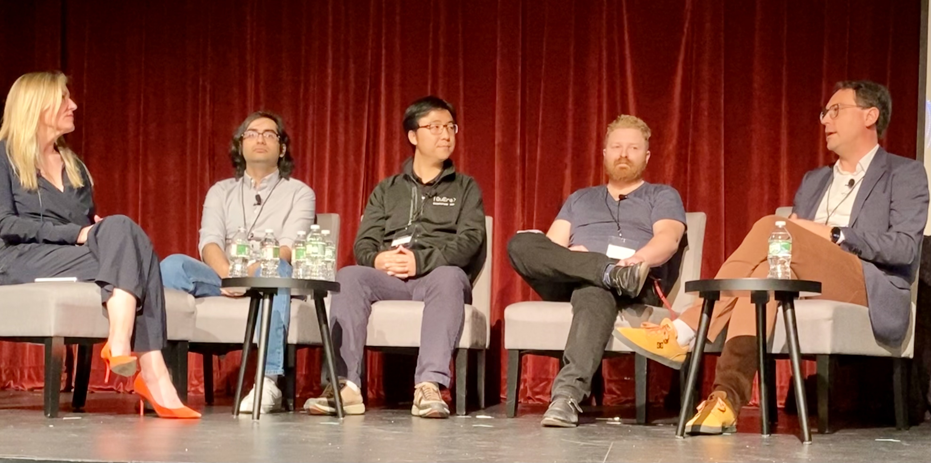 Panelists at "Convergence: The Promise and Reality of AI & Quantum" conference onstage